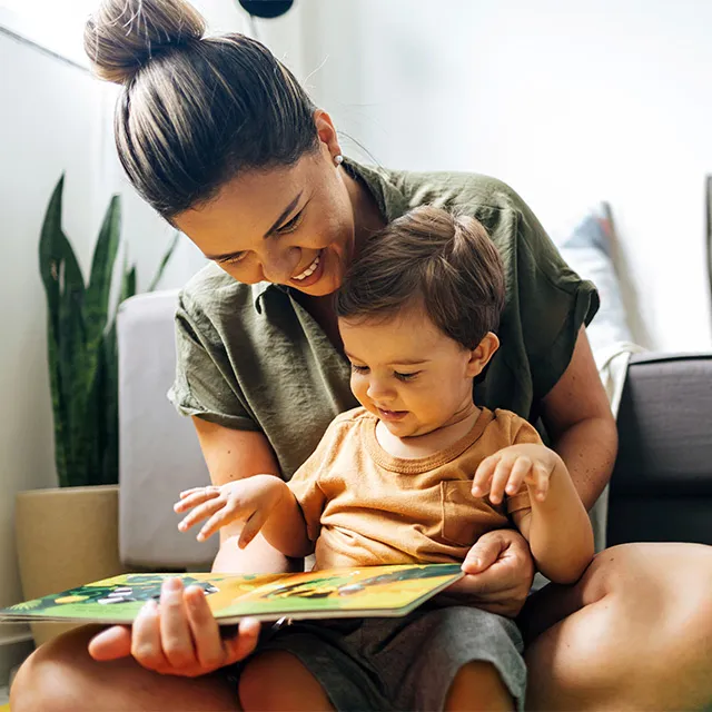 mom reading book to child